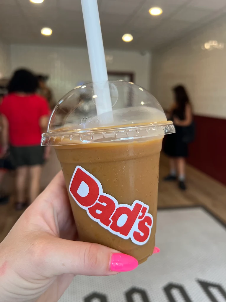 Dad’s coffee slushy in a clear takeaway cup with the red Dad’s logo