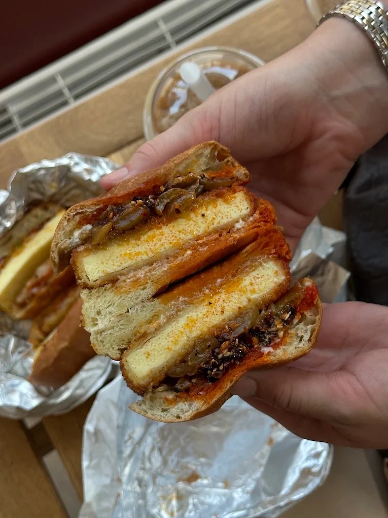 A close-up of two halves of Dad’s Katsu sandwich