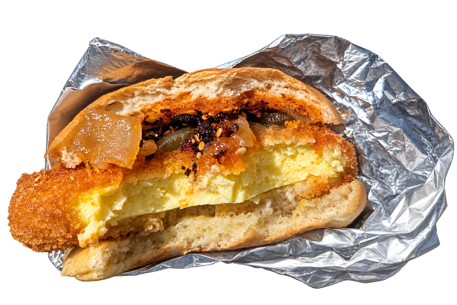 Dad’s Katsu breakfast sandwich: crispy panko egg, onions and chili crisp in a bun, served in silver foil